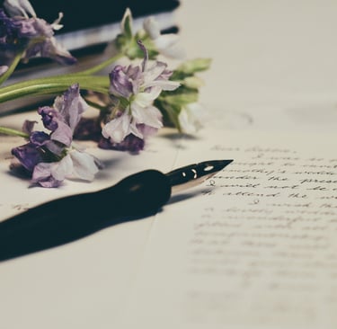Image of purple flowers on paper. Photo credit: Unsplash and Debby Hudson