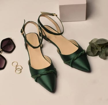 a pair of green shoes and sunglasses on a table