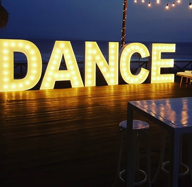 a large light up sign that says dance