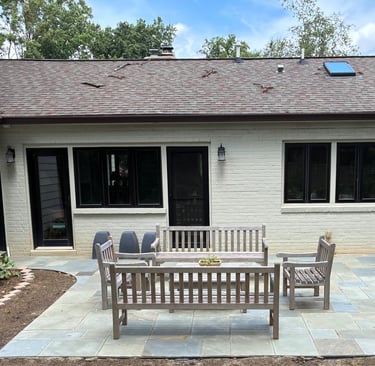 Backyard patio with curved walkways connecting to outside doors