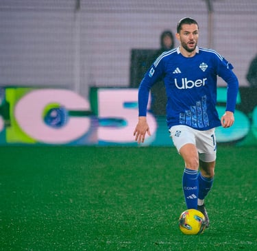 a soccer player is playing soccer on a field