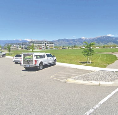a van parked in a parking lot with mountains in the background