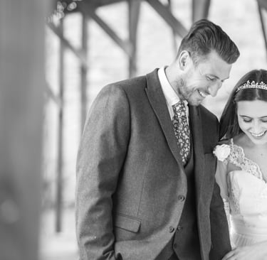 candid photo of bride and groom walking holding hands laughing and having a good time