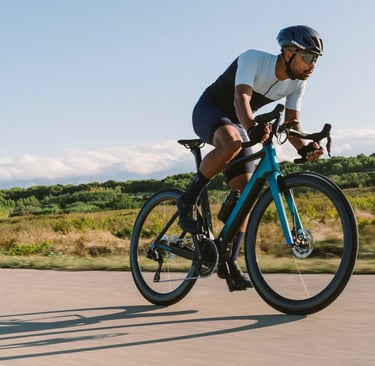 a man riding a bicycle on a road