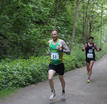 a man running on a path in a wooded area