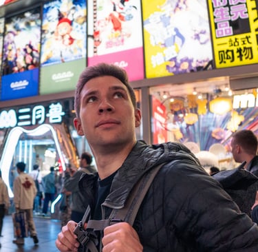 a man standing in front of a building with a backpack on his back
