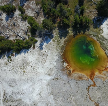 a large geothermal blue pool in yellowstone national park
