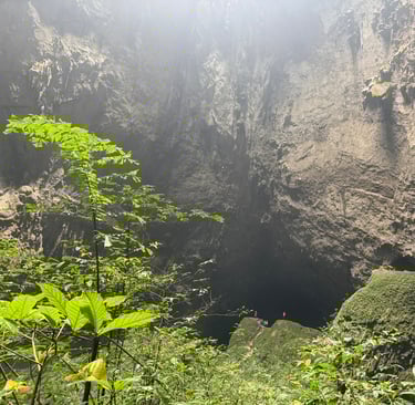 standing at the entrance to the cave in doline 1, Hang Son Doong Cave, Vietnam