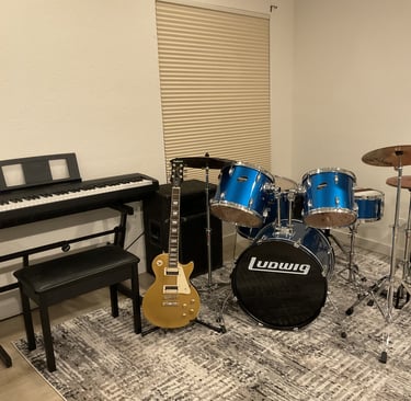 a room with a piano, guitar, and a piano
