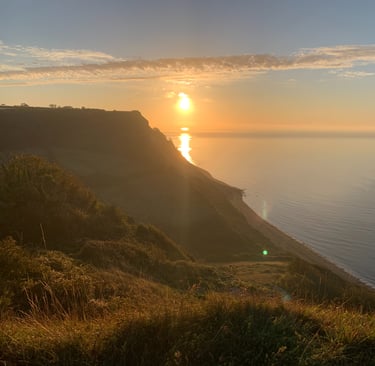 A view of the sunset overlooking the ocean and coast