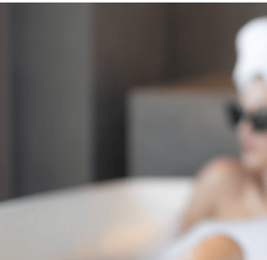 a woman in a towel and selfcare products