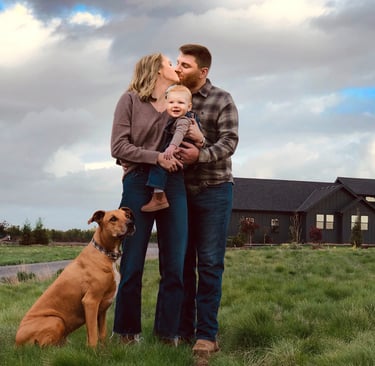 a family and dog standing in front of a house