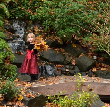 a little girl in a red dress holding a leaflet