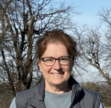 Farm owner standing alone in the field.