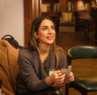 Female workshop participant, smiling during public speaking exercise in Berlin