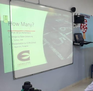 A teacher standing at the front of a classroom.