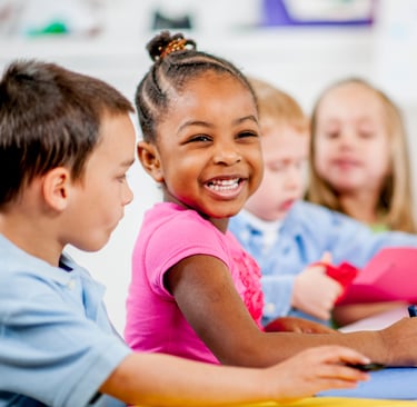 Children smiling and coloring