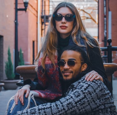 Man and woman modeling stylish sunglasses in downtown Fort Collins