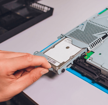 a person is holding a piece of a hard drive