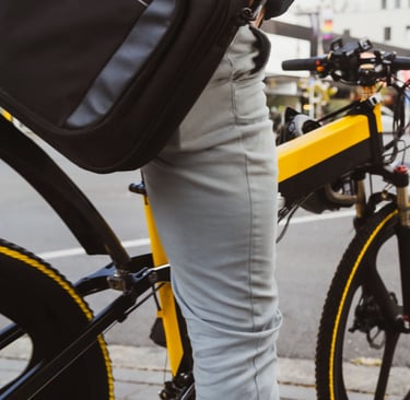 a person riding a bike on a city street