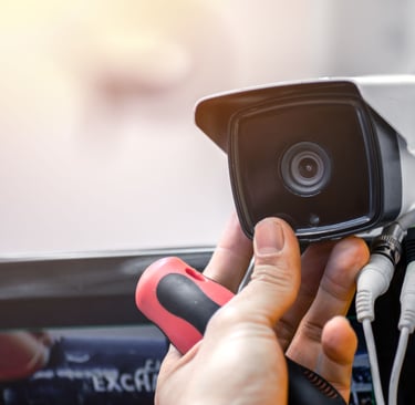 a person holding a camera and a camera