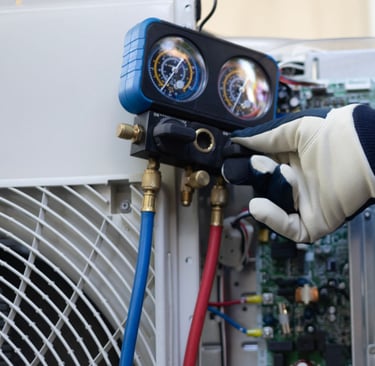 a person in a blue jacket and gloves holding a hose and a hose