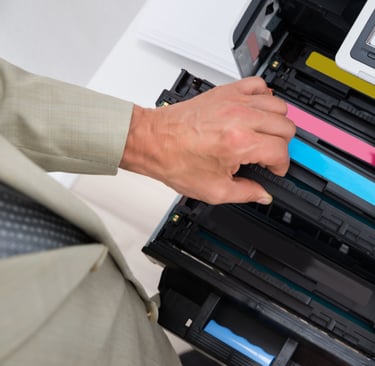 a man is holding a printer and a printer