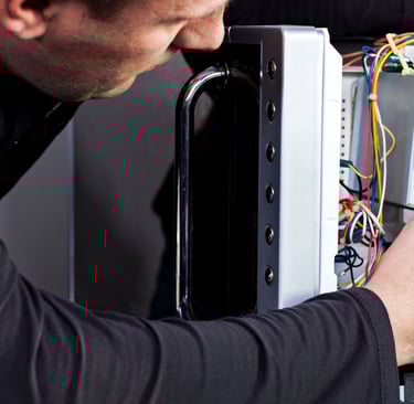 a man is fixing a computer monitor in a computer