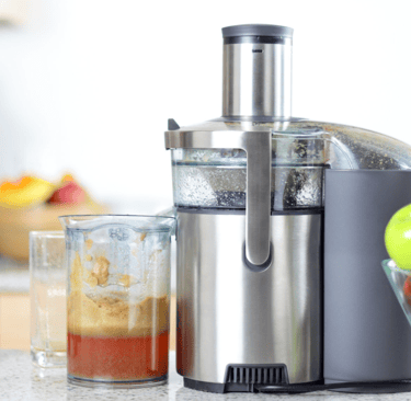 a blender with apples and apples in a bowl