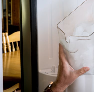 a person holding a piece of paper in front of a refrigerator