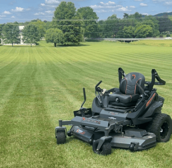 mower at idle with cut grass in background