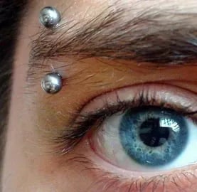 Safe eyebrow piercing performed with hypoallergenic jewellery