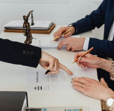 Couple signing divorce papers in a lawyers office dissolving their marriage