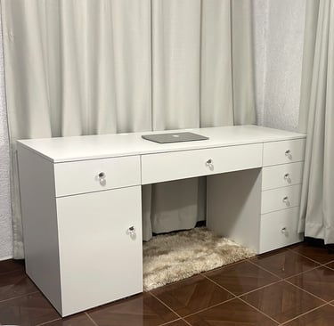 a desk with a computer desk and a laptop