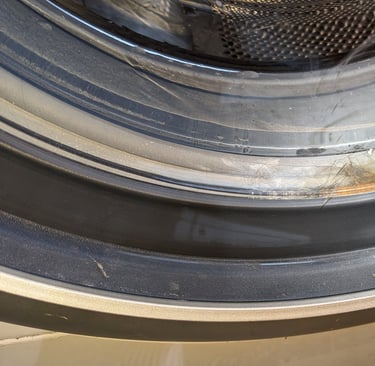 Front load washer door with stuck hair