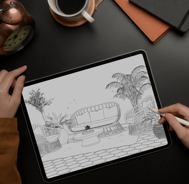 Artist sketching on a digital tablet for the Artful Interiors coloring book.