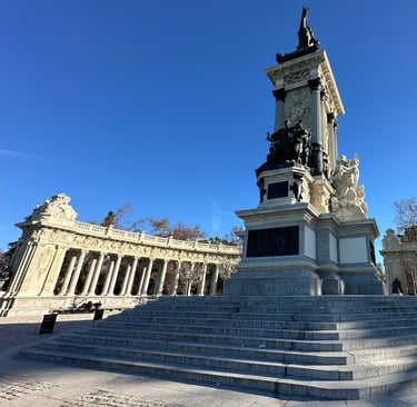 A statue of a man, horseback and on a pedestal surrounded by a portcullis