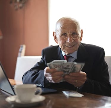 retired individual holding money symbolizing his retirement savings and wealth