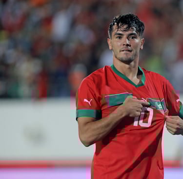 a man in a red shirt is holding a shirt