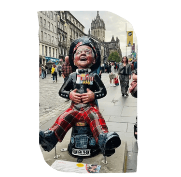 Oor Wullie statue wearing tartan trousers, holding his belly and laughing