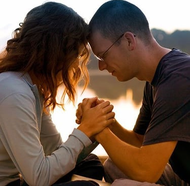A married couple praying together