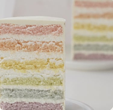 a slice of cake with a rainbow - colored layers