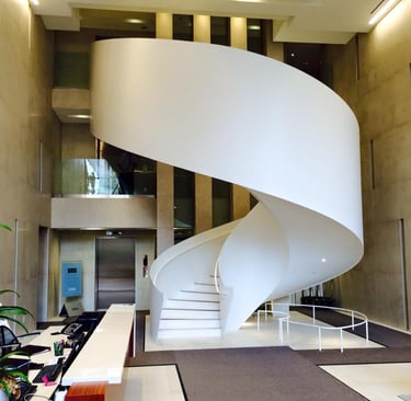 Uniquely beautiful elliptical feature staircase in residential building's lobby, by Pengelly Iron Works