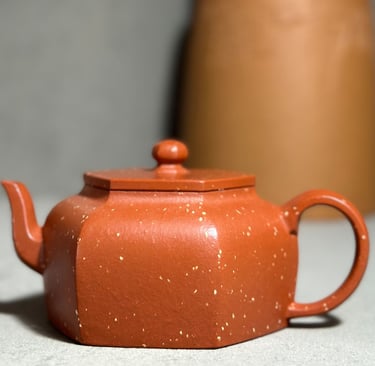 Brown teapot placed on a gray surface