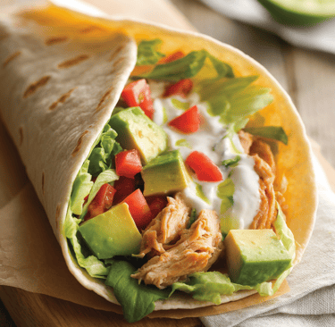 Low-carb chicken avocado wrap with shredded chicken, diced avocado, fresh lettuce, chopped tomatoes