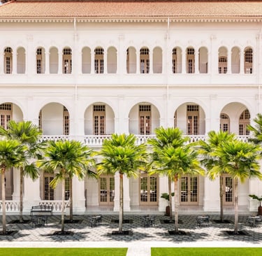 Colonial facade and courtyard of Raffles Hotel Singapore.