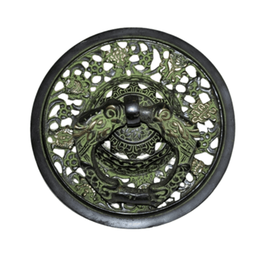 a decorative metal plate with a green dragonfly