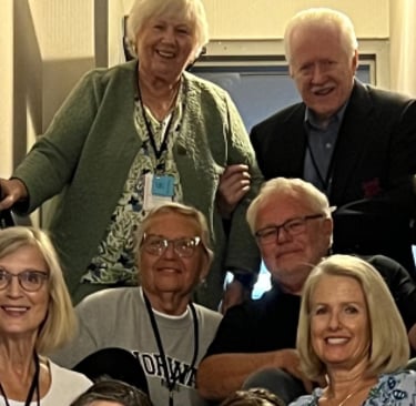 twelve Telelaget members sit in a stairwell