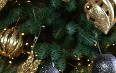 a christmas tree with presents and presents on a wooden floor