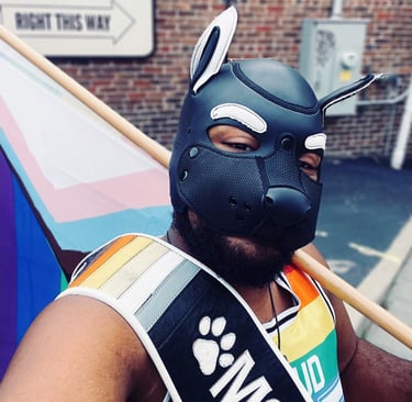 A man in a pup mask walking in a parade.